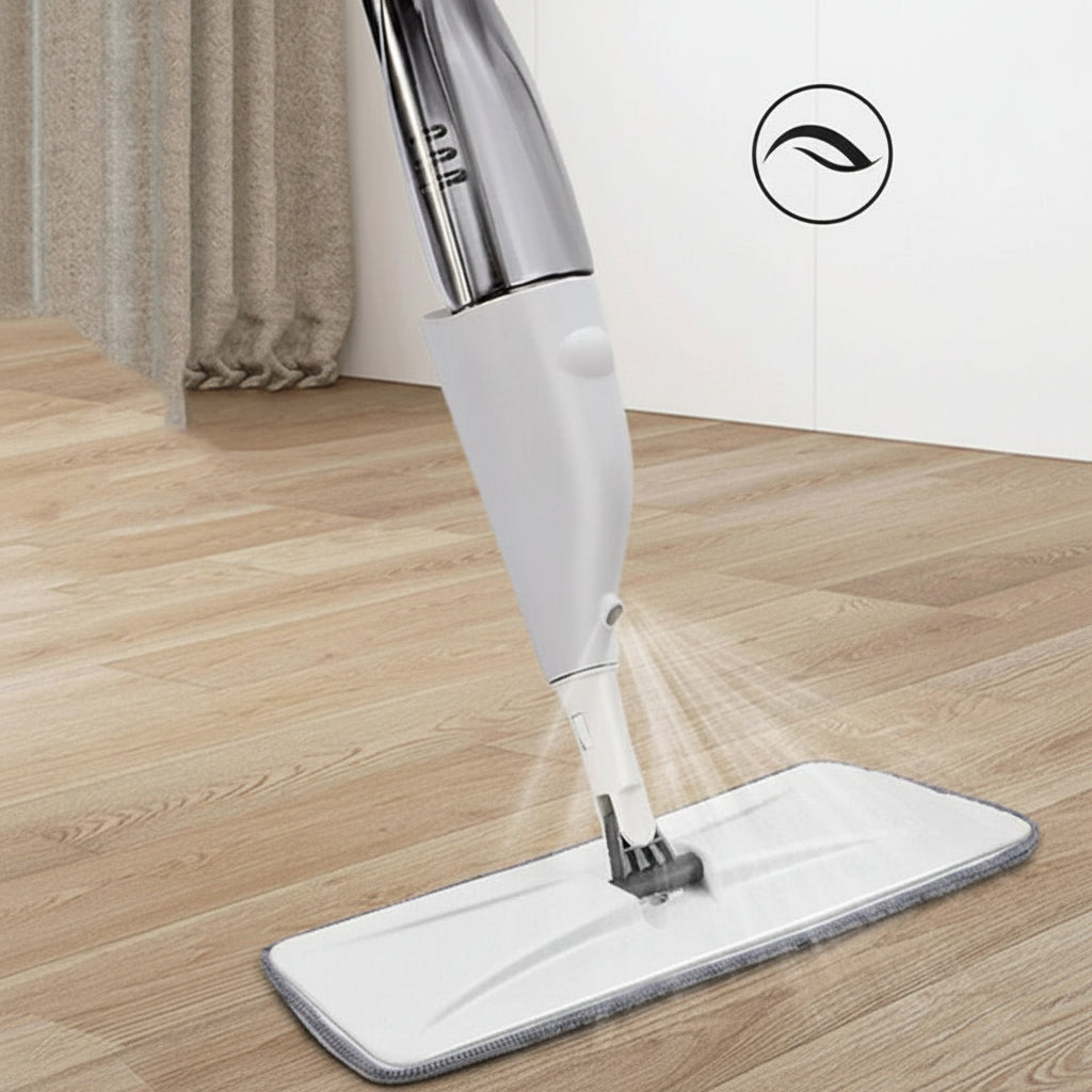 White handheld steam cleaner with a gray pad on a wooden floor.