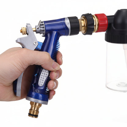 Hand holding a blue spray gun with a white background