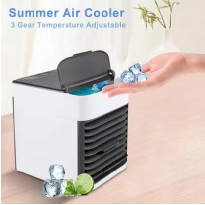 Portable air cooler with ice cubes and lime on a wooden surface