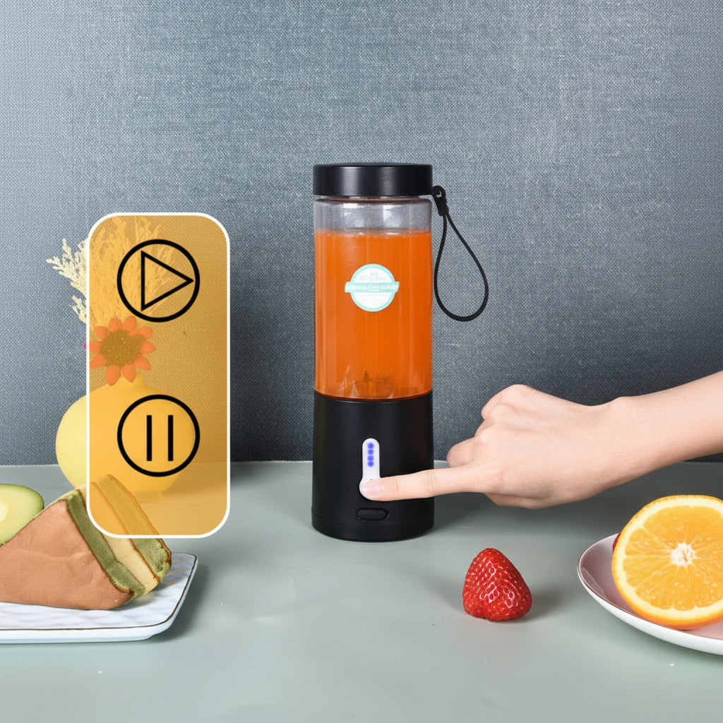Black portable blender with orange juice on a gray surface, surrounded by fruits.